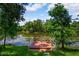 Lakeside backyard featuring a cozy deck with outdoor seating, offering a tranquil view at 4267 Adelaide Ave, North Port, FL 34288