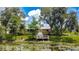 Beautiful home's exterior with a dock on the water, surrounded by lush greenery at 4267 Adelaide Ave, North Port, FL 34288