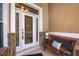 Inviting front door with decorative glass, sidelights, and a cozy bench at 4267 Adelaide Ave, North Port, FL 34288
