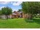 Beautiful home with a well-manicured lawn and mature trees at 4267 Adelaide Ave, North Port, FL 34288