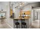 Inviting kitchen featuring wooden cabinets, granite countertops, and a breakfast bar with seating at 4267 Adelaide Ave, North Port, FL 34288