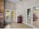 View of living room with stone fireplace, French doors to lanai and entry to another room at 4267 Adelaide Ave, North Port, FL 34288