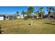 Large fenced backyard with grassy lawn and bird bath at 514 Orlando Blvd, Port Charlotte, FL 33954