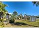 Spacious backyard with lush landscaping and a storage shed at 514 Orlando Blvd, Port Charlotte, FL 33954