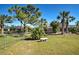 Fenced backyard with stone bench and mature landscaping at 514 Orlando Blvd, Port Charlotte, FL 33954