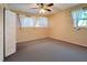 Bright bedroom with ceiling fan, window coverings, and ample closet space at 514 Orlando Blvd, Port Charlotte, FL 33954