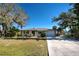 Ranch-style home with a two-car garage and lush landscaping at 514 Orlando Blvd, Port Charlotte, FL 33954