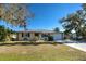Inviting ranch-style home with a well-manicured lawn and mature trees at 514 Orlando Blvd, Port Charlotte, FL 33954