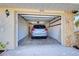 Attached garage with space for one vehicle and storage shelving at 514 Orlando Blvd, Port Charlotte, FL 33954