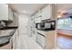 Efficient kitchen featuring white cabinets, granite countertops, and modern appliances at 514 Orlando Blvd, Port Charlotte, FL 33954