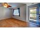Living room with wood flooring, ceiling fan, and window with curtains at 514 Orlando Blvd, Port Charlotte, FL 33954