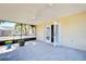 Screened porch with access door to interior and ceiling fan at 514 Orlando Blvd, Port Charlotte, FL 33954