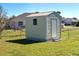 Tan storage shed with white door and window at 514 Orlando Blvd, Port Charlotte, FL 33954