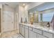 Double vanity bathroom with granite countertops and a large shower at 5274 Grove Mill Loop, Bradenton, FL 34211