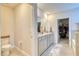 Bathroom with double vanity, walk-in closet, and bathtub at 5274 Grove Mill Loop, Bradenton, FL 34211