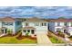 Two-story house with gray siding, landscaping, and a two-car garage at 5274 Grove Mill Loop, Bradenton, FL 34211