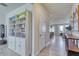 Bright hallway with built-in shelving and view to living area at 5274 Grove Mill Loop, Bradenton, FL 34211