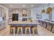 Open kitchen with granite counters, island, and stainless steel appliances at 5274 Grove Mill Loop, Bradenton, FL 34211