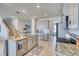 Modern kitchen with granite island, stainless steel appliances, and breakfast bar at 5274 Grove Mill Loop, Bradenton, FL 34211