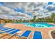 Community pool with lounge chairs and brick deck at 5274 Grove Mill Loop, Bradenton, FL 34211