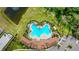 Community pool with lounge chairs and surrounding landscaping at 5274 Grove Mill Loop, Bradenton, FL 34211