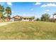 Tan house with brown roof, palm trees, and American flag at 716 Mirado Nw Ln, Port Charlotte, FL 33948