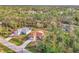 Aerial view of two houses nestled in a wooded neighborhood at 7849 Franzino Ave, North Port, FL 34291