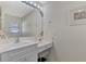 Vanity with a white countertop and a large mirror at 7849 Franzino Ave, North Port, FL 34291