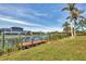 Wooden dock on a calm waterway, surrounded by lush greenery at 9214 Snapper Cir, Port Charlotte, FL 33981