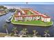 Aerial view of a waterfront condo complex featuring boat docks and waterfront views at 1 Colony Point Dr # A19, Punta Gorda, FL 33950