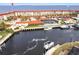 Aerial view of a waterfront condo with a boat dock, pool, and ample parking at 1 Colony Point Dr # A19, Punta Gorda, FL 33950