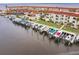 Aerial view of waterfront apartments with boat docks on a clear day at 1 Colony Point Dr # A19, Punta Gorda, FL 33950