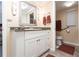 Bathroom with a vanity, granite countertop, and accessible toilet area at 1 Colony Point Dr # A19, Punta Gorda, FL 33950