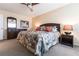 King-size bed, dark wood furniture, and tropical bedding at 1 Colony Point Dr # A19, Punta Gorda, FL 33950