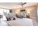 Cozy living room with striped sofas, soft rug, ceiling fan, and natural lighting at 1 Colony Point Dr # A19, Punta Gorda, FL 33950