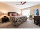 Comfortable main bedroom features a king-size bed, ceiling fan, ample lighting, and tropical decor at 1 Colony Point Dr # A19, Punta Gorda, FL 33950