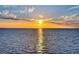 Beautiful sun setting on a serene sea featuring reflective light trails on the water at 1 Colony Point Dr # A19, Punta Gorda, FL 33950