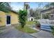 Landscaped backyard with shed, patio, and walkway at 103 Atwater St, Port Charlotte, FL 33954