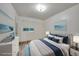 Virtually staged bedroom with gray bedding and ocean artwork at 103 Atwater St, Port Charlotte, FL 33954