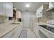 White kitchen with granite countertops and modern appliances at 103 Atwater St, Port Charlotte, FL 33954