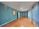 Bright living room with light wood floors and teal walls at 103 Atwater St, Port Charlotte, FL 33954