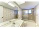 Bathroom with bathtub, shower, and seashell decor at 1115 Venture Ct, Punta Gorda, FL 33983