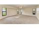 Spacious bedroom with carpeted floors and multiple windows at 1115 Venture Ct, Punta Gorda, FL 33983