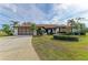 Single-story home with attached garage and manicured landscaping at 1115 Venture Ct, Punta Gorda, FL 33983