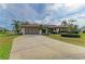 Single-story home with a screened garage and landscaped yard at 1115 Venture Ct, Punta Gorda, FL 33983