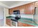 Kitchen boasts wood cabinets and green countertops at 1115 Venture Ct, Punta Gorda, FL 33983