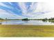 Serene lakefront view with lush green grass at 1115 Venture Ct, Punta Gorda, FL 33983