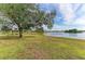 Peaceful lakefront property with lush green grass at 1115 Venture Ct, Punta Gorda, FL 33983