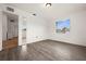 Bedroom with wood-look floors and access to bathroom at 12071 Claremont Dr, Port Charlotte, FL 33981