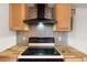 Kitchen with wood cabinets and tin backsplash at 12071 Claremont Dr, Port Charlotte, FL 33981